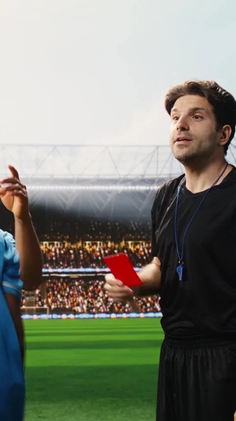 Vertical Video Referee showing second yellow card and eliminating blue team Stock Footage 338046905