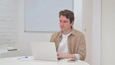Vertical Video, Rejecting Young Man in Denial while Working on Laptop Video stock 312914349