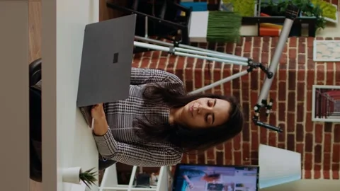 Vertical video Relaxed freelancer checking her emails on notebook device from Stock Footage 264420162
