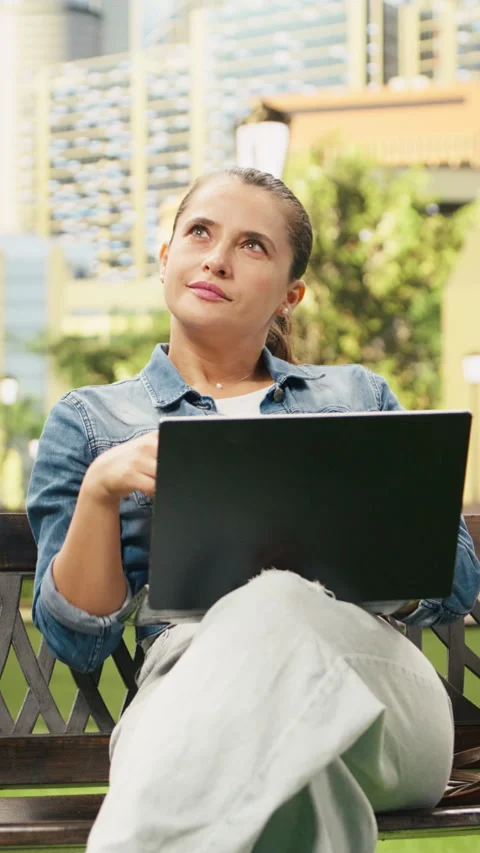 Vertical Video Relaxed woman using laptop for remote work while drinking coffee Stock Footage 344377326