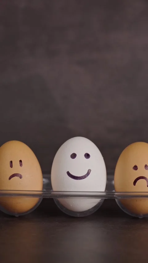 Vertical video, representation of different moods, two brown eggs with sad faces Stock Footage 281372766