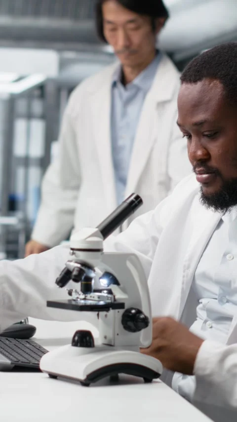 Vertical video Researcher operating compound microscope, doing sample Stock Footage 319506434