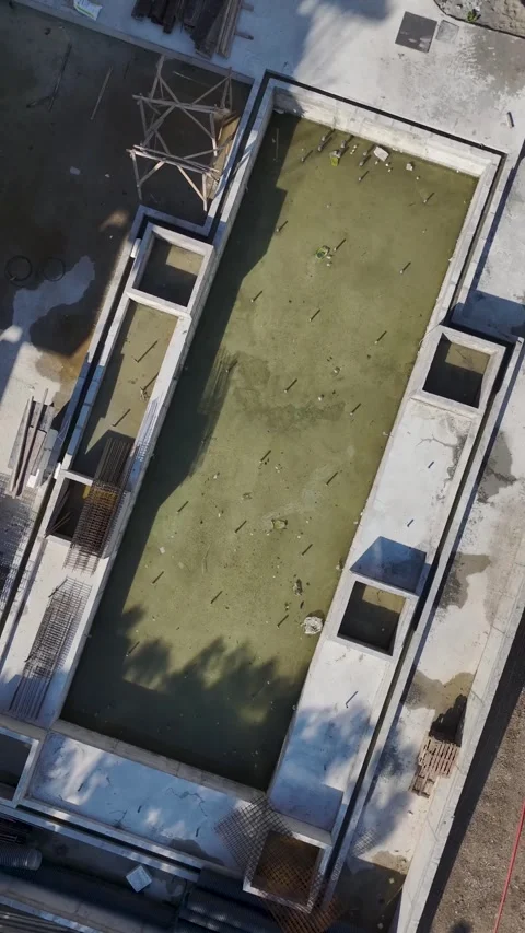 Vertical Video: Residential project construction site buzzing as workers pour Stock Footage 297653724
