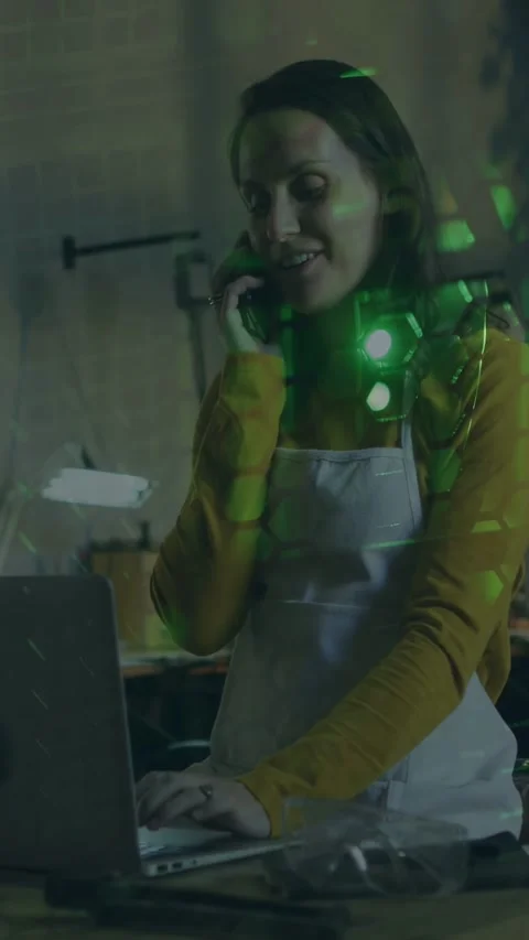Vertical video: Retailer taking call and typing order on laptop, green hex Stock Footage 333692095