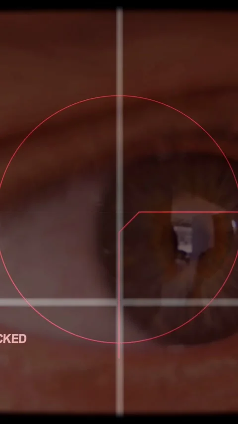 Vertical video: Reticle starting centered scanning brown iris, pointer sliding Stock Footage 340133534
