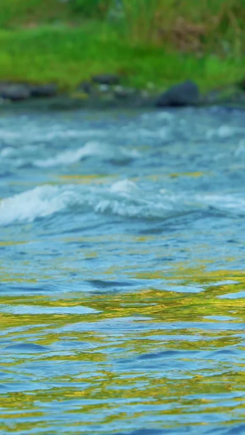 Vertical video of rippling blue river water Stock Footage 336318316