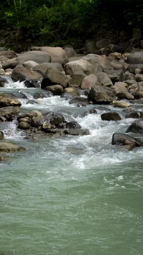 Vertical video of a rocky river flowing in the mountains Stock-Footage 336878682