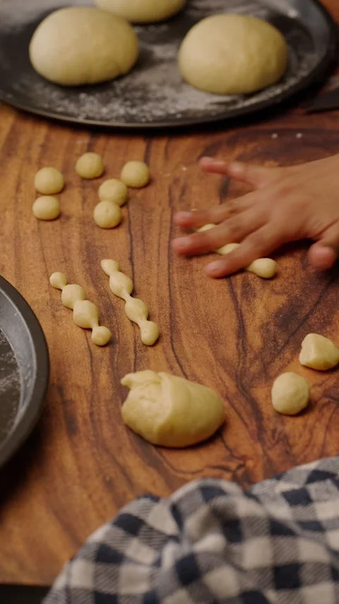Vertical video, rolling yeast dough to make traditional pan de muerto Stock Footage 282499718