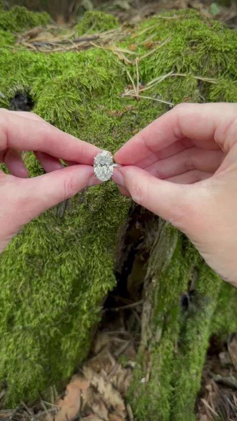Vertical video of romantic hand gesture with solitaire diamond ring Stock Footage 317335585