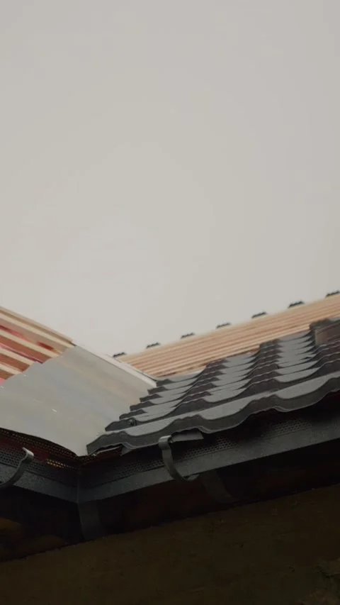 Vertical video Roof construction process featuring metal tiles and wood framing Stock Footage 327603449