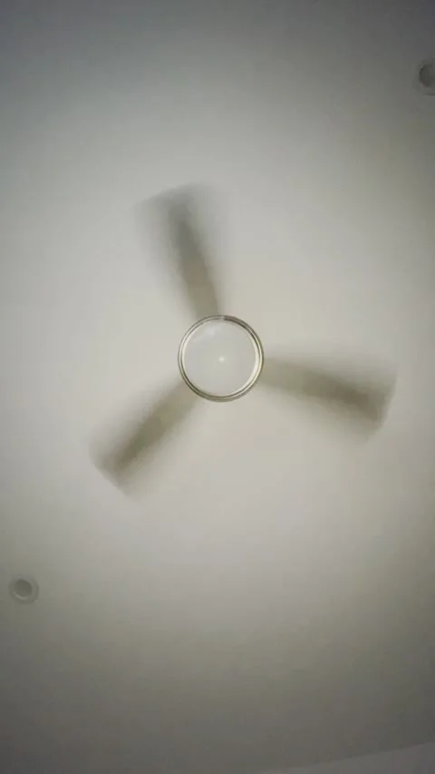Vertical video of a rotating ceiling fan at hotel in Los Angeles Stock Footage 322736510