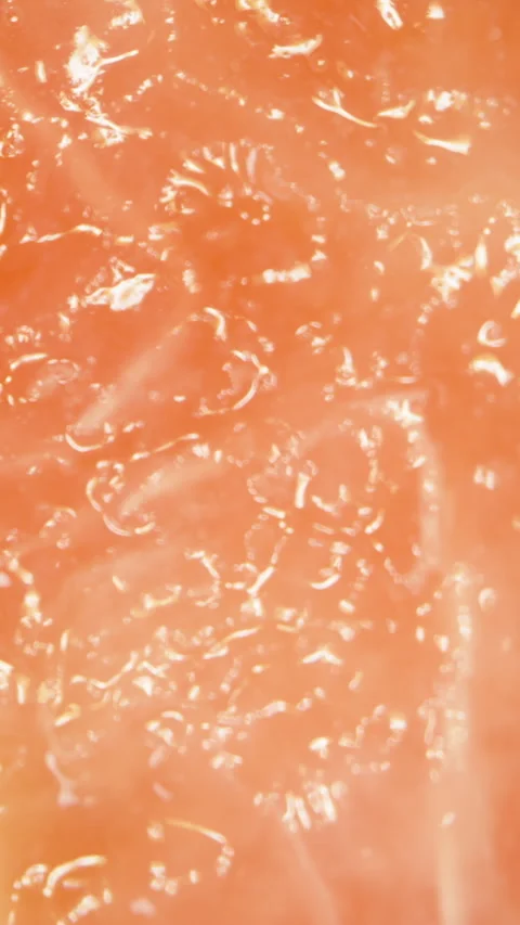 Vertical video. Rotating Macro Close-Up of Pink Guava Flesh Showing Juicy Stock Footage 311027194