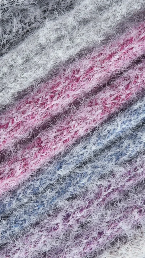 Vertical video of rotating mink and cashmere wool fabric in grey, pink, and blue Stock Footage 318004838