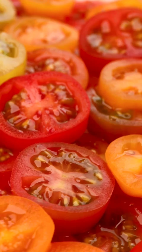Vertical video. rotating view of sliced multicolored cherry tomatoes Stock Footage 321832664