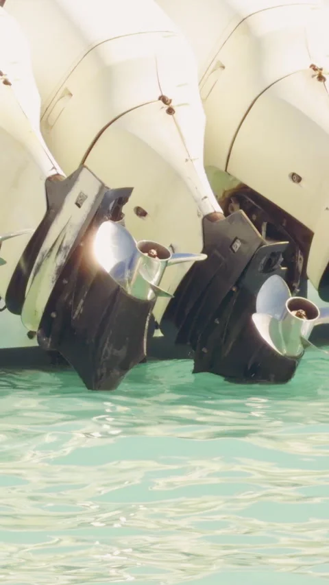 Vertical video. Row Of Boat Outboard Motors Above Clear Turquoise Water In Marin Stock Footage 337024779