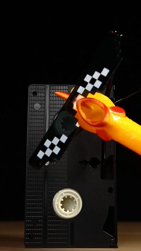 Vertical video of rubber chicken vhs tape dark background Video stock 243566418