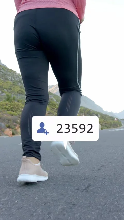 Vertical video: Runner jogging mountain road, movement spawning social icons Stock Footage 333840334