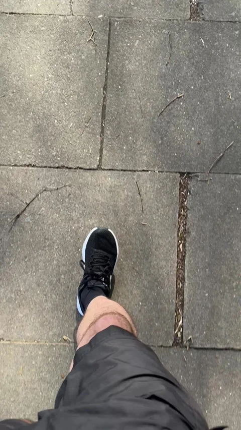 Vertical video of running man on the city pavement Видео 333974093