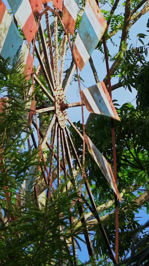Vertical video of rustic Thai flag windmill spinning in the wind Stock Footage 348358222