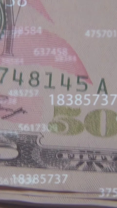 Vertical video: On scan, camera panning over stacked 50s, numbers floating to Stock Footage 335678150