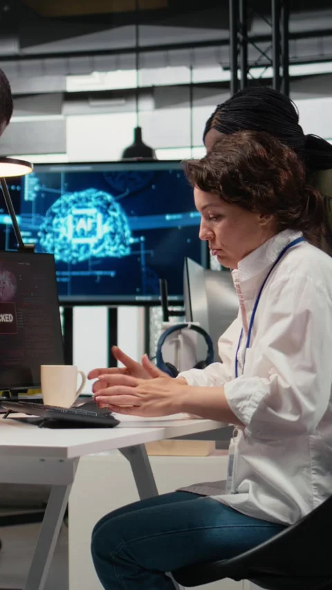Vertical video Scared admins in office panicked by alert, trying to stop hacker Stock Footage 323142105