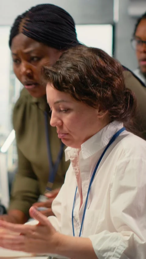Vertical video Scared admins in office panicked by alert, trying to stop hacker Stock Footage 323236471
