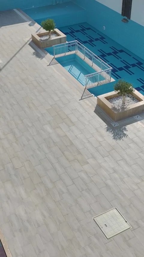 Vertical Video: Scenic Old Pool Captured Vertically with Overgrown Grass and Stock Footage 342915783