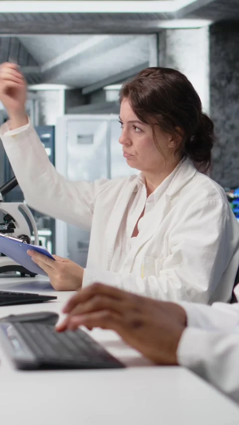 Vertical video Scientist records observations in lab, doing validation of Stock Footage 319506249