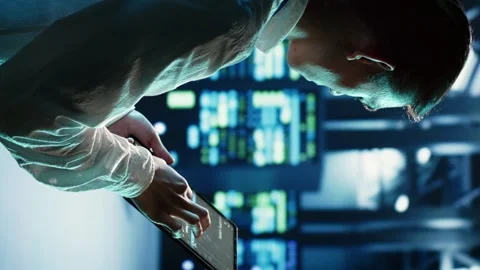 Vertical video Scientist runs code in data center Stock Footage 250360847