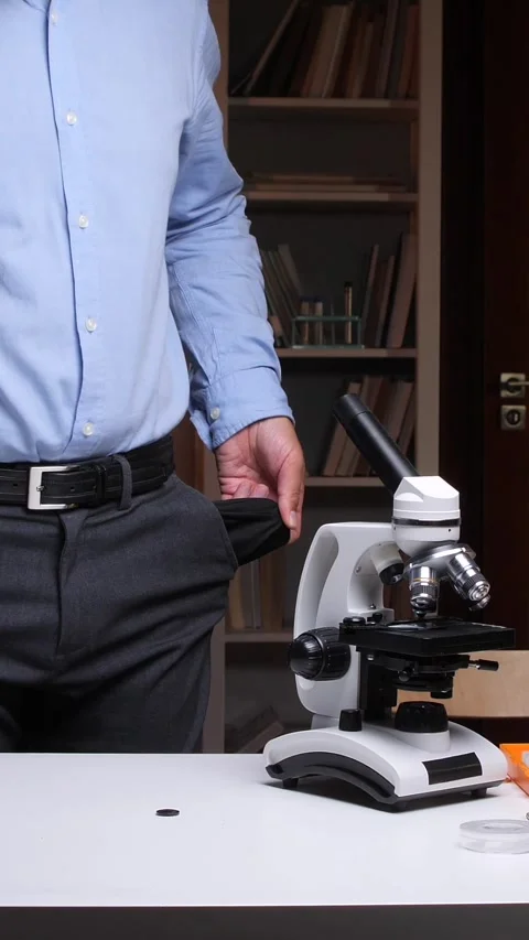 Vertical video Scientist showing empty pockets in his office after funding cuts Video stock 313275156