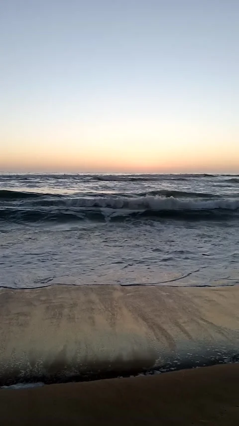 Vertical video of the sea and waves during sunset Stock Footage 233381542