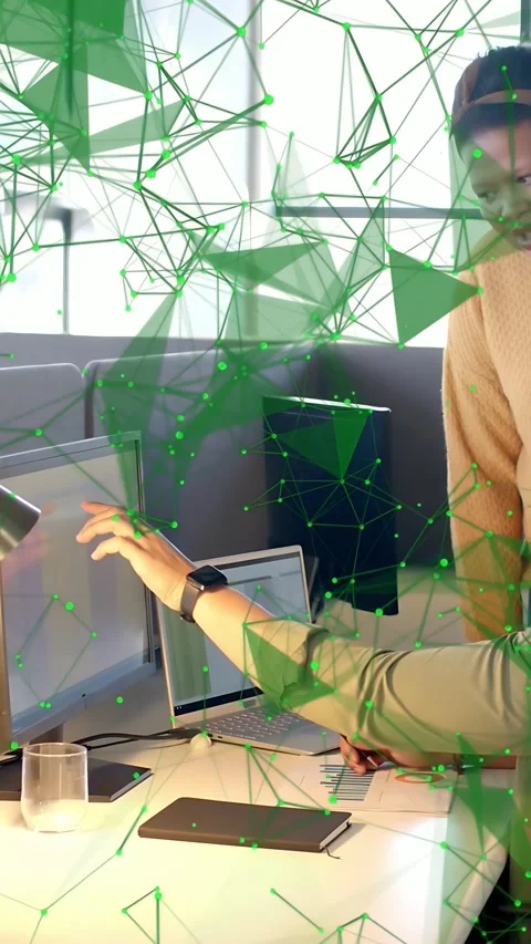 Vertical video: Seated dev touching laptop peer watching tech overlay reacting Stock Footage 333596450