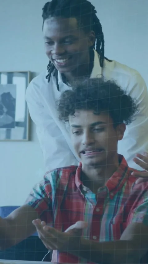 Vertical video: Seated dev typing to debug code, standing mentor pointing, code Stock Footage 330965786
