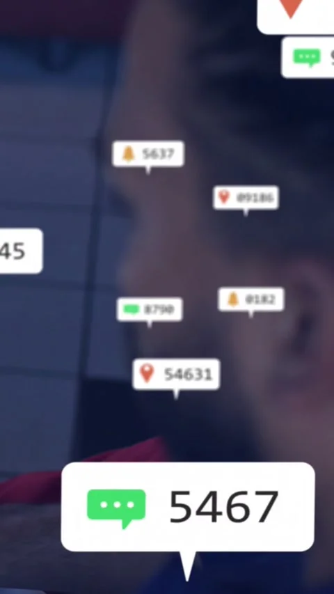 Vertical video: Seated man by blinds, live alerts popping chat badges, updating Stock Footage 330286529