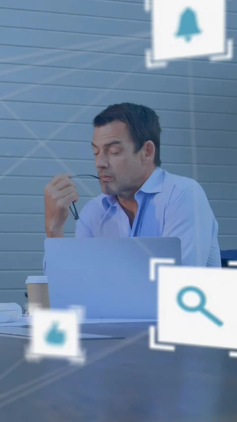 Vertical video: Seated man with glasses looking at laptop ping, launching social Stock Footage 330306141