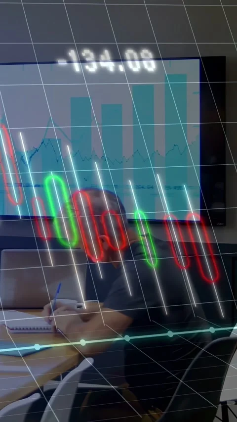 Vertical video: Seated man noting values at table as data feed driving AR Stock Footage 334540430