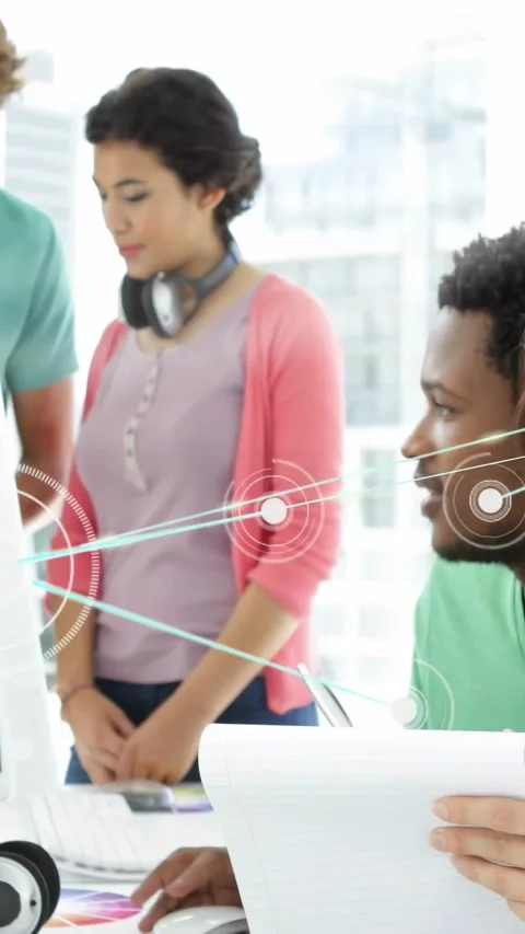 Vertical video: Seated man using mouse, pointing screen, team checking design Stock Footage 332546658