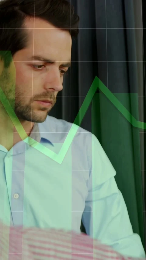 Vertical video: Seated man watching peer gesturing and studying green chart Stock Footage 332734687