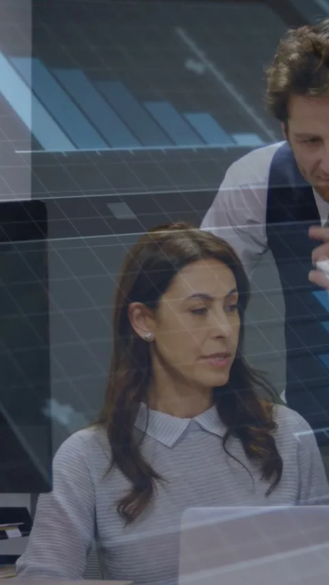 Vertical video: Seated woman using laptop he leaning pointing reviewing smiling Stock Footage 331178298