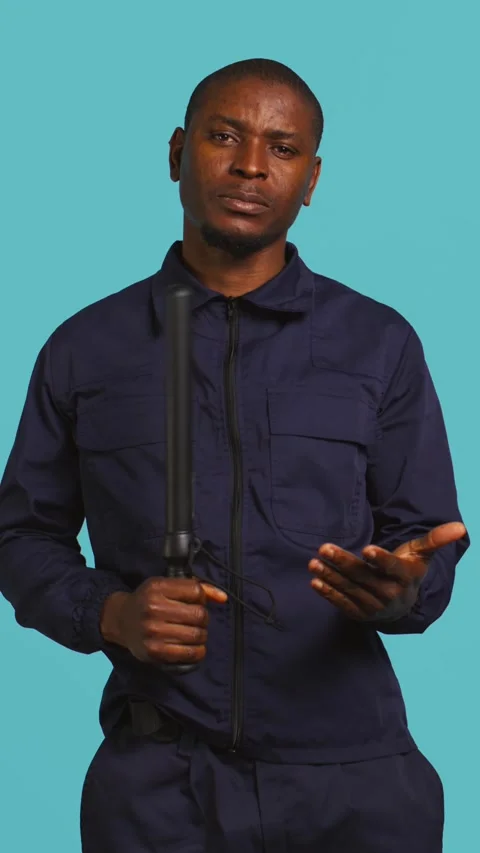 Vertical video Security guard smacking hand with baton, intimidating suspects Stock Footage 277425541