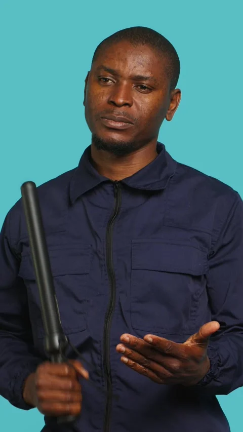 Vertical video Security guard smacking hand with baton, intimidating suspects Stock Footage 277964127