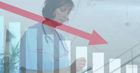 Vertical video: Seeing red arrow on chart, clinic nurse in scrubs noting Stock Footage 334182453