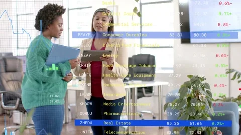 Vertical video: Seeing stock data, beige blazer tapping tablet, green top Stock Footage 333221458