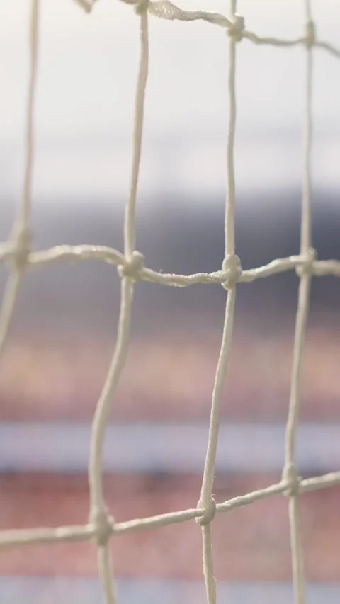 Vertical Video Selective focus goal net and post detail on football pitch under Stock Footage 338047439