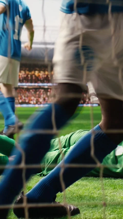 Vertical Video Selective focus of soccer ball hitting net and crossing goal post Stock Footage 338047831