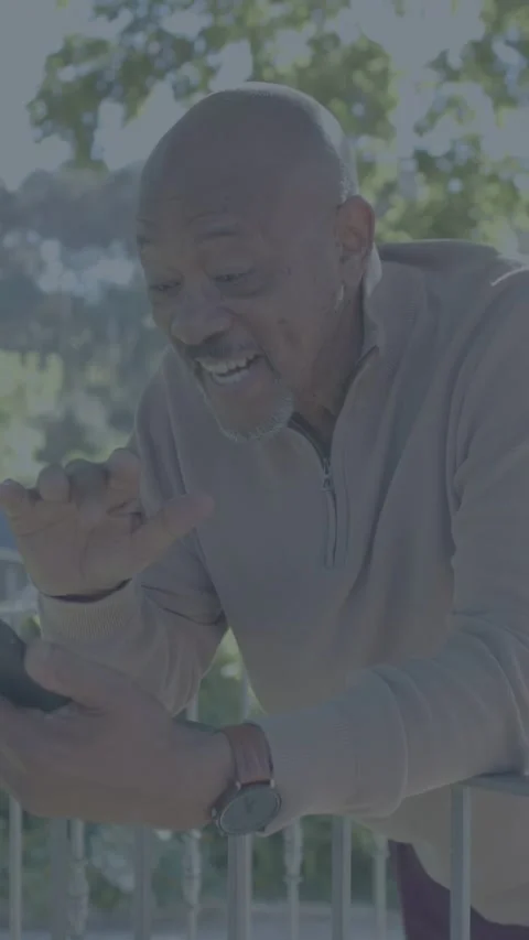 Vertical video: Senior man leaning porch tapping phone firing UI icons reacting Stock Footage 333513624