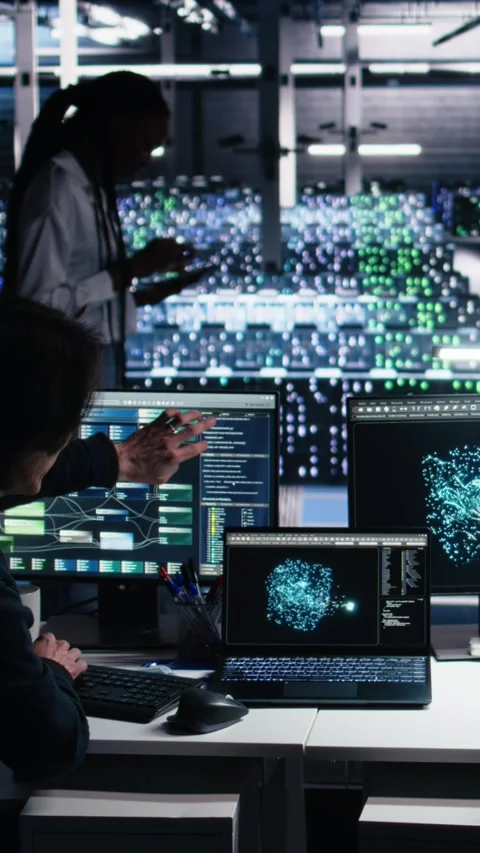 Vertical video Senior programmer and coworker in data center coding with Stock Footage 313507860