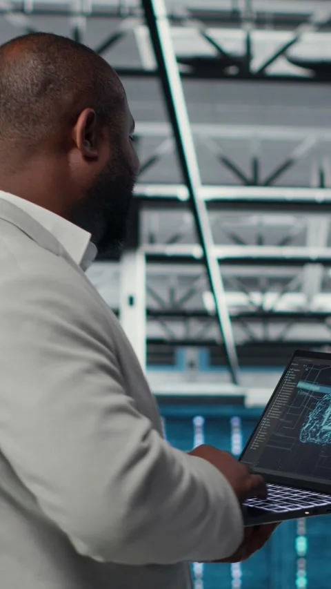 Vertical video Server farm IT specialist using laptop to improve deep learning Stock Footage 311489272
