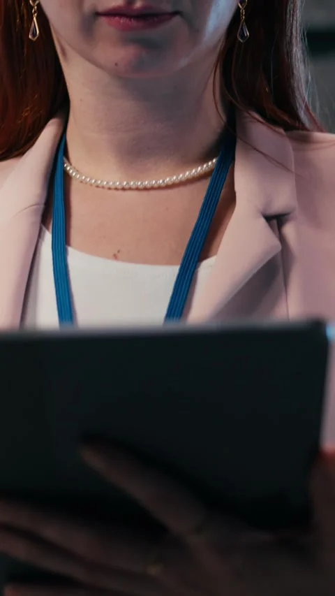 Vertical video Server farm IT specialist using tablet app to do network Stock Footage 330375545