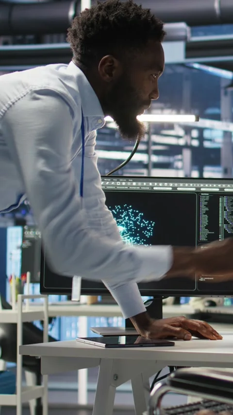 Vertical video Server farm supervisor and man with disability oversee AI Video stock 308757059